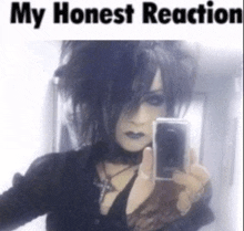 a goth girl taking a selfie with the words my honest reaction below her