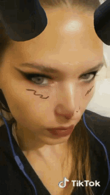 a close up of a woman 's face with a tiktok watermark