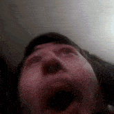 a close up of a person 's face with their mouth open .