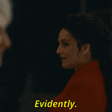 a woman in a red jacket says evidently while looking at a man