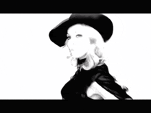 a black and white photo of a woman in a hat