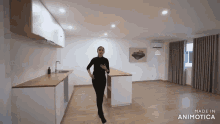 a woman is standing in an empty kitchen with the words made in animotica behind her