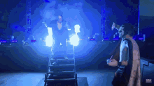 a wrestler is walking down a set of stairs while another wrestler looks on ..
