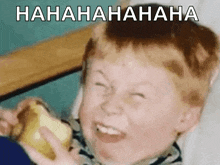a young boy is making a funny face while holding a banana and the words ' hahahaha ' are above him