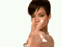a woman with short hair is pointing her finger at the camera .