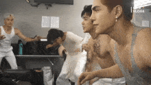 a group of young men are standing in a room with the words sons vlog on the bottom right