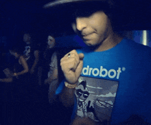 a man wearing a blue shirt that says robot