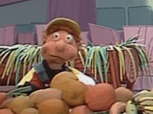 a cartoon character is holding a bunch of fruit in his hands