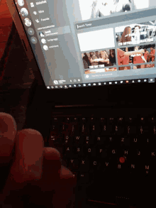 a person is typing on a laptop with the word search typed at the top of the screen