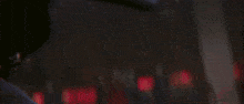 a close up of a person holding a gun in front of a wall
