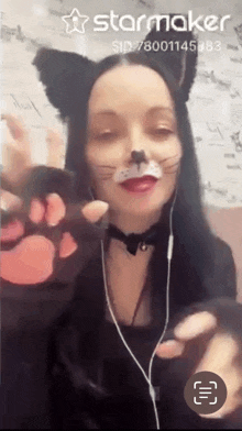 a woman wearing cat ears and paw gloves is on a starmaker video