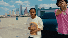 a man in a pink shirt stands next to a woman in a white shirt in a parking lot
