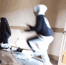 a person wearing a hoodie is jumping in the air
