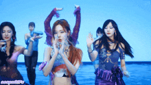 a group of women are dancing in front of a blue background that says ncspngifs