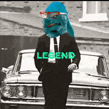 a man in a suit and tie is standing in front of a car with the word legend on it