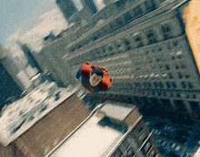 a man in a superman costume is flying through the air above a city