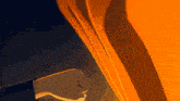 a person 's hand is reaching out towards a yellow curtain