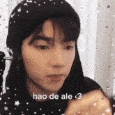 a close up of a person 's face with the words hao de ale < 3 on the bottom