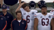 a group of chicago bears players are standing in a huddle