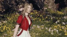 a woman in a red jacket and white dress standing in a field of flowers