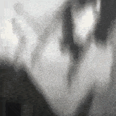 a black and white photo of a person 's face with a blurry background .