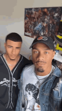 two men are posing for a picture with one wearing a hat that says smith on it