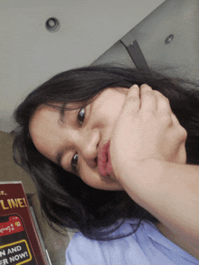 a girl is making a funny face in front of a sign that says ' king 's ' on it