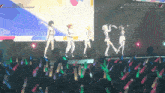 a group of people are dancing on a stage with a sign that says #regloss3d