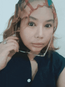 a woman with glasses and a scarf around her head