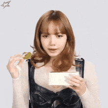 a woman holding a piece of food in her hand with a star above her head