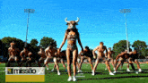 a group of men are dancing on a field with the word missao on the bottom right