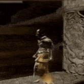 a statue of a man is dancing in a dark room in front of a stone wall .