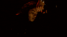 a man with red paint on his face is smiling
