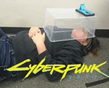 a person is laying on the floor with a plastic container on their head and the word cyberpunk on the bottom