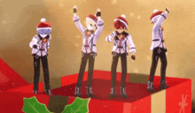 a group of anime characters are dancing on top of a christmas present box .
