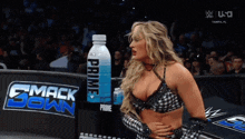 a woman standing in front of a smack down sign