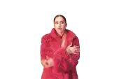 a woman in a red fur coat is holding a piece of paper in her hand