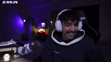 a man wearing headphones and a hat that says o.ja9 mast