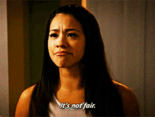 a woman says it 's not fair while making a funny face
