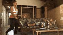 a man laying on a couch with a bottle of rum on the table