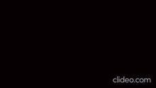a cartoon character is laying in a pile of trash with the website clideo.com at the bottom of the screen