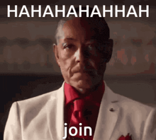 a man in a white suit and red tie is laughing with the words join below him