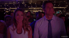 a man and a woman are smiling in front of a crowd with the hashtag youngertv on the bottom right