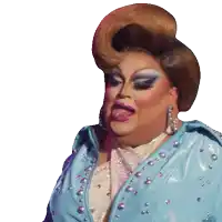 a drag queen wearing a blue jacket with pearls on it sticks out her tongue