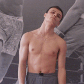 a shirtless man is standing in front of a sign that says finish him !