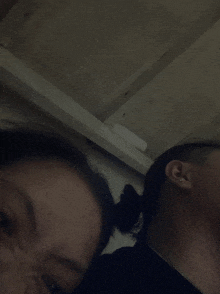 a man and a woman are looking at the camera