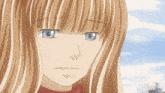 a girl with blonde hair and blue eyes is looking down