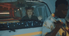 a man and a woman in a van with the words www.bandicam.com on the bottom of the screen