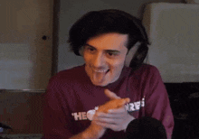 a young man wearing headphones is making a funny face while sticking his tongue out .