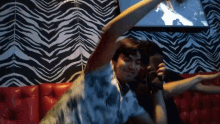 a man sitting on a red couch with his arms outstretched